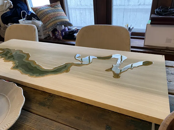 A river table with green resin water